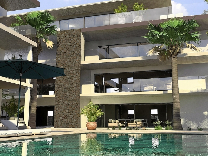 Modern apartment complex featuring a swimming pool, stone accent wall, and spacious balconies with glass railings, showcasing contemporary architectural design.