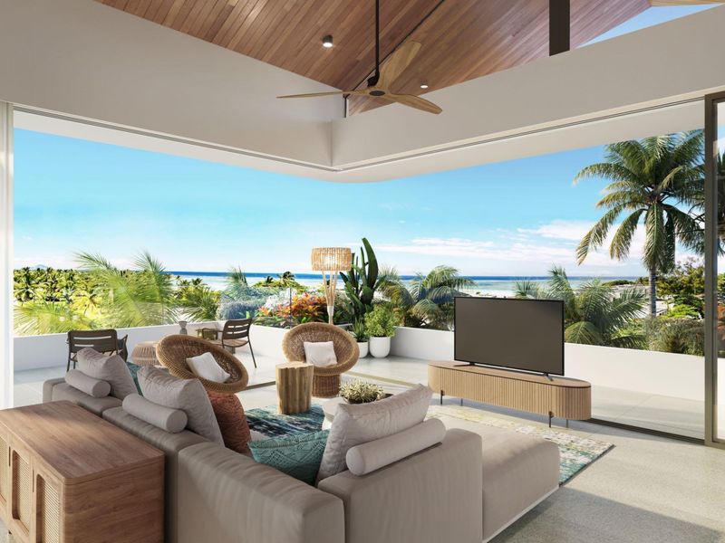 Spacious open-plan living area seamlessly flowing onto a large covered balcony with panoramic ocean views and high-end architectural finishes.