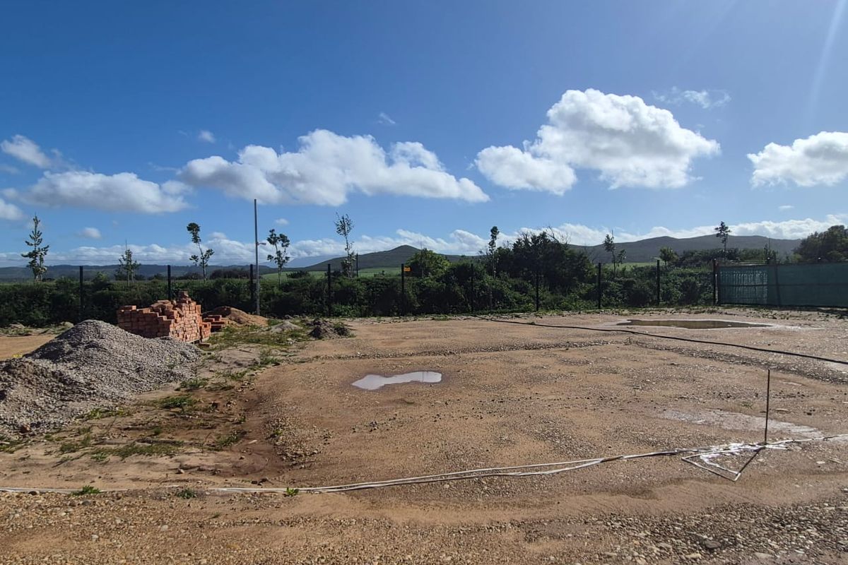 A vacant plot of land featuring perimeter fencing and scenic mountain views, suitable for future development.