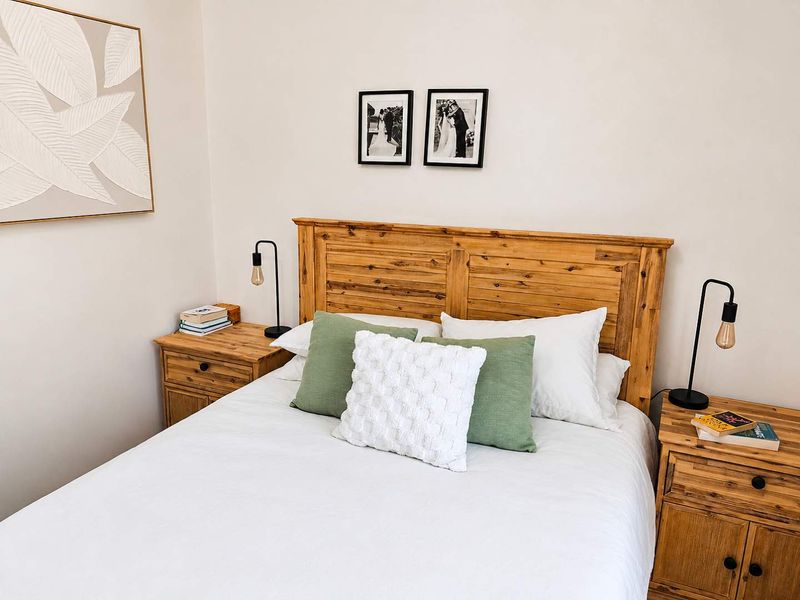 A well-maintained bedroom featuring neutral walls and a clean, modern aesthetic.