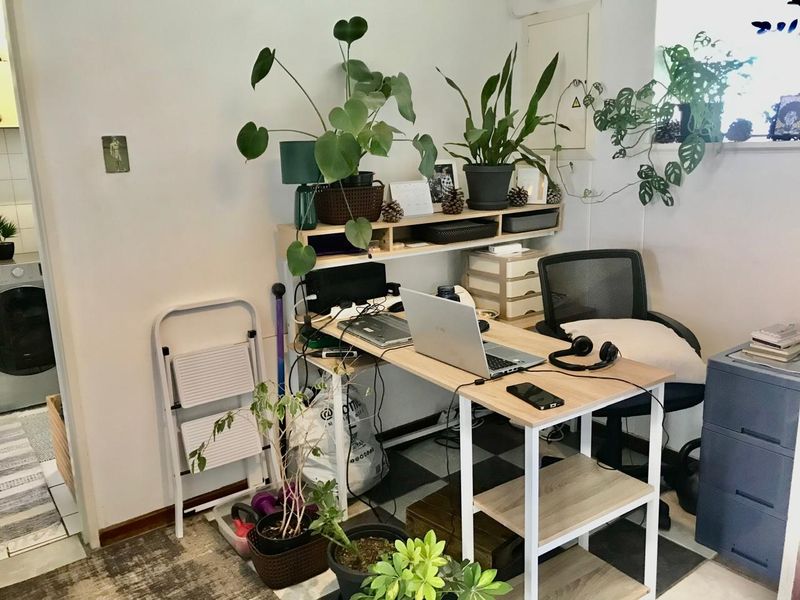 A functional home office space featuring a built-in electrical distribution board and neutral wall finishes.