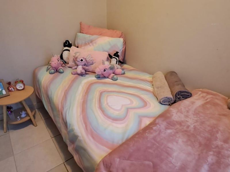 A compact bedroom featuring tiled flooring and neutral wall finishes, suitable for a single bed setup.