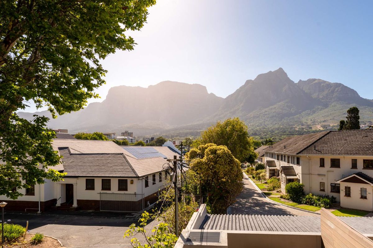Elevated view overlooking the surrounding residential complex with prominent mountain scenery in the background.