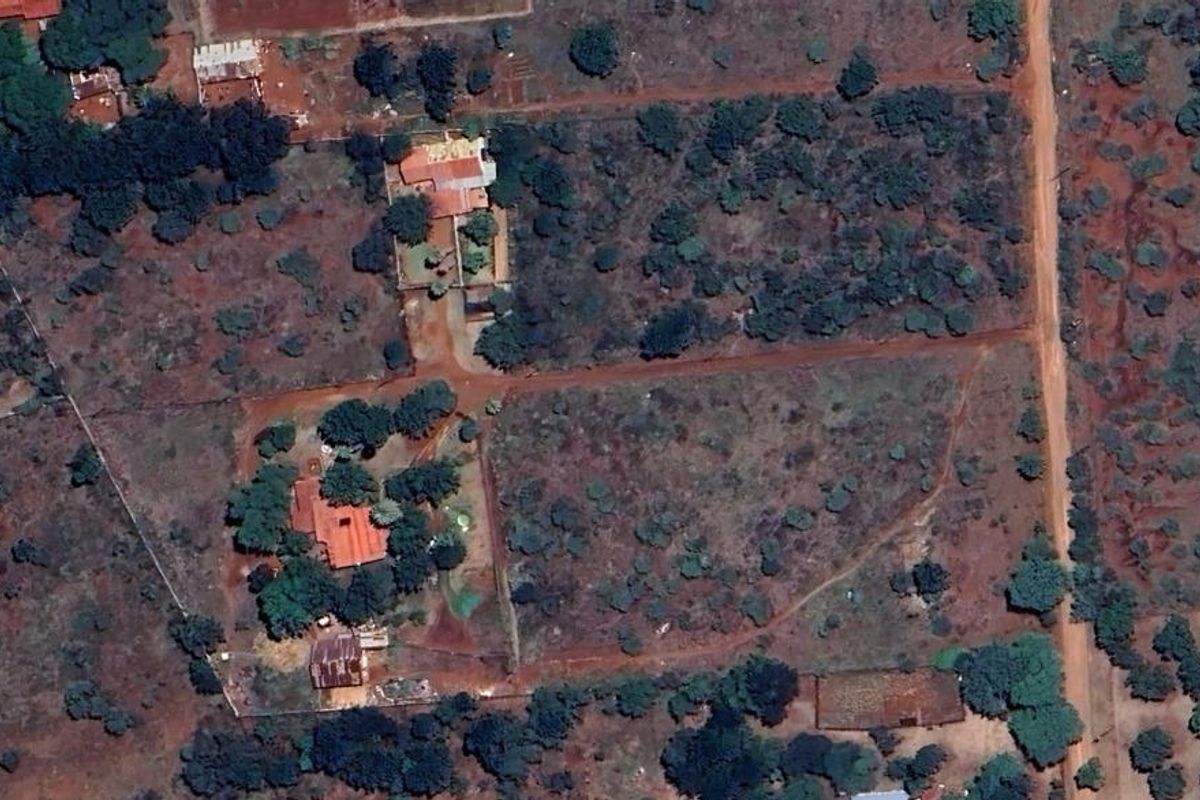 Aerial view of the small holding property, showcasing the layout of the main dwelling, outbuildings, and surrounding land.