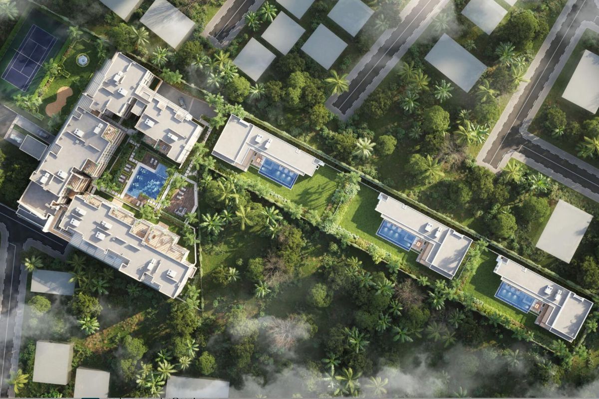 Aerial view of a residential estate featuring multiple modern buildings, private swimming pools, landscaped gardens, and a tennis court.