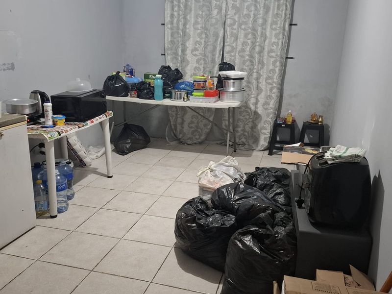 A basic kitchen area featuring tiled flooring and neutral wall finishes, currently requiring renovation and modernization to improve functionality and aesthetic appeal.