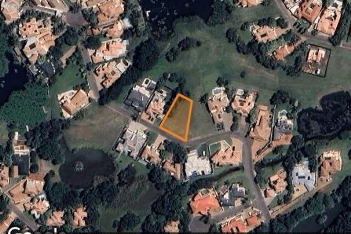 Aerial view of a vacant residential plot highlighted within a developed estate, showcasing its location and surrounding neighborhood context.