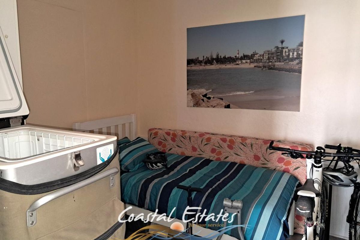 A bedroom space featuring neutral wall finishes, suitable for use as a guest room or additional sleeping area.