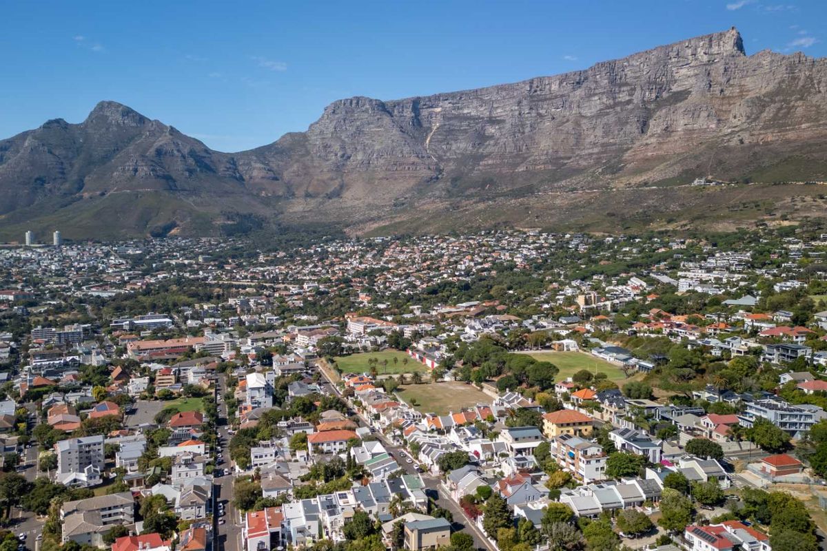 An elevated aerial view showcasing the residential neighborhood and surrounding landscape with Table Mountain in the background.