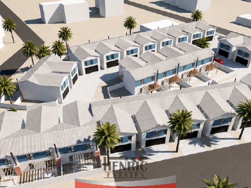 An aerial 3D render of a modern townhouse development featuring multiple units, paved driveways, private patios, and landscaped grounds.