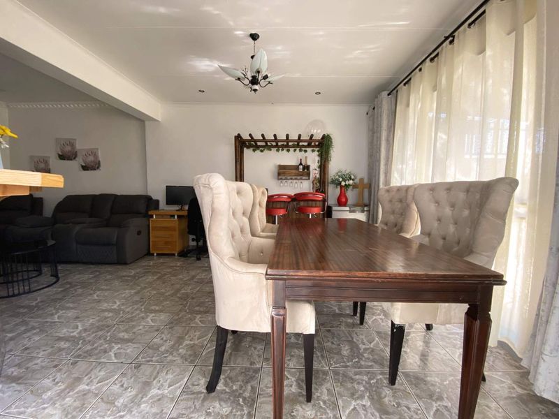 Open plan living and dining area featuring tiled flooring and neutral wall finishes, providing a versatile space for family living and entertaining.