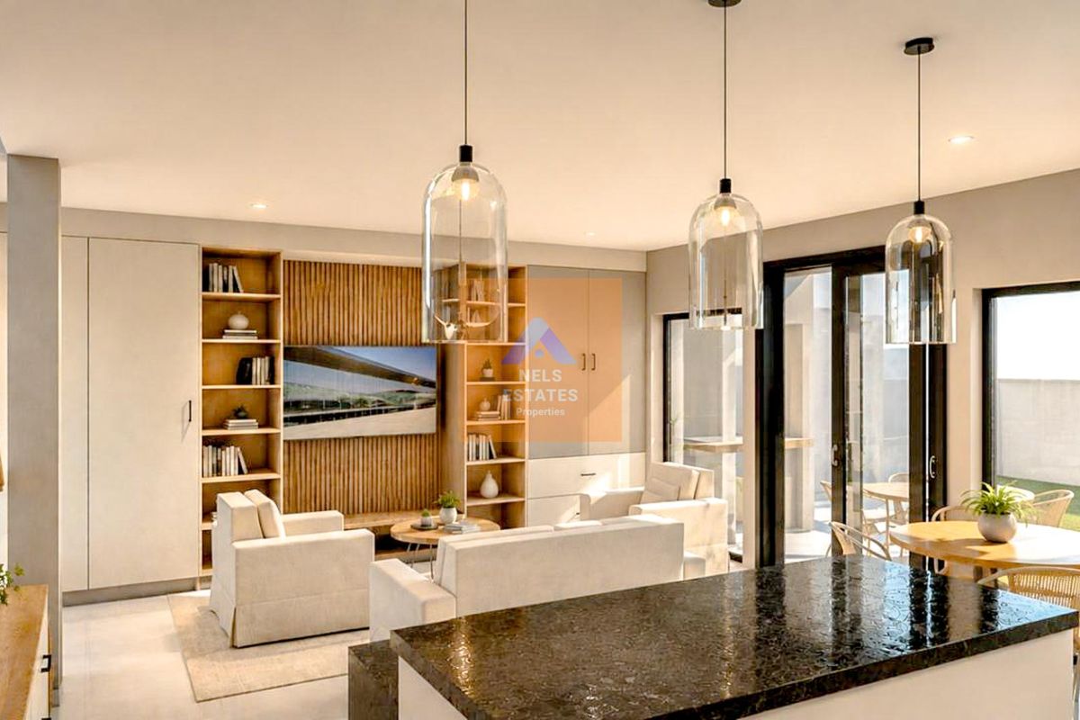 Modern open-plan living area featuring a granite kitchen island, custom built-in shelving, slatted timber wall detail, and seamless access to the outdoor patio.