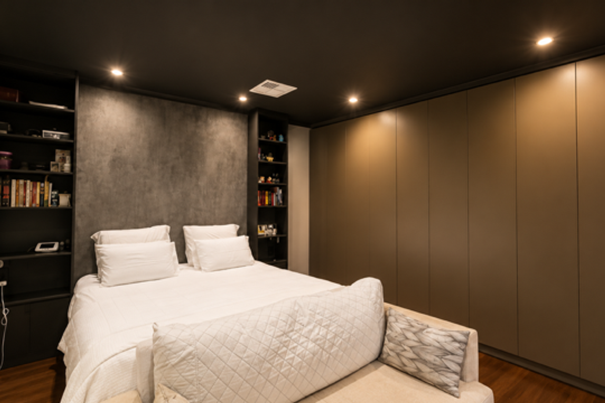 Modern bedroom featuring built-in floor-to-ceiling wardrobes, integrated shelving units, recessed downlighting, and dark ceiling finishes.