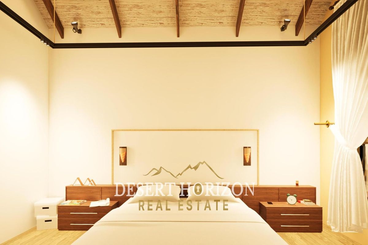 A modern bedroom featuring a vaulted timber ceiling, integrated wooden headboard with built-in bedside cabinetry, and warm ambient lighting.