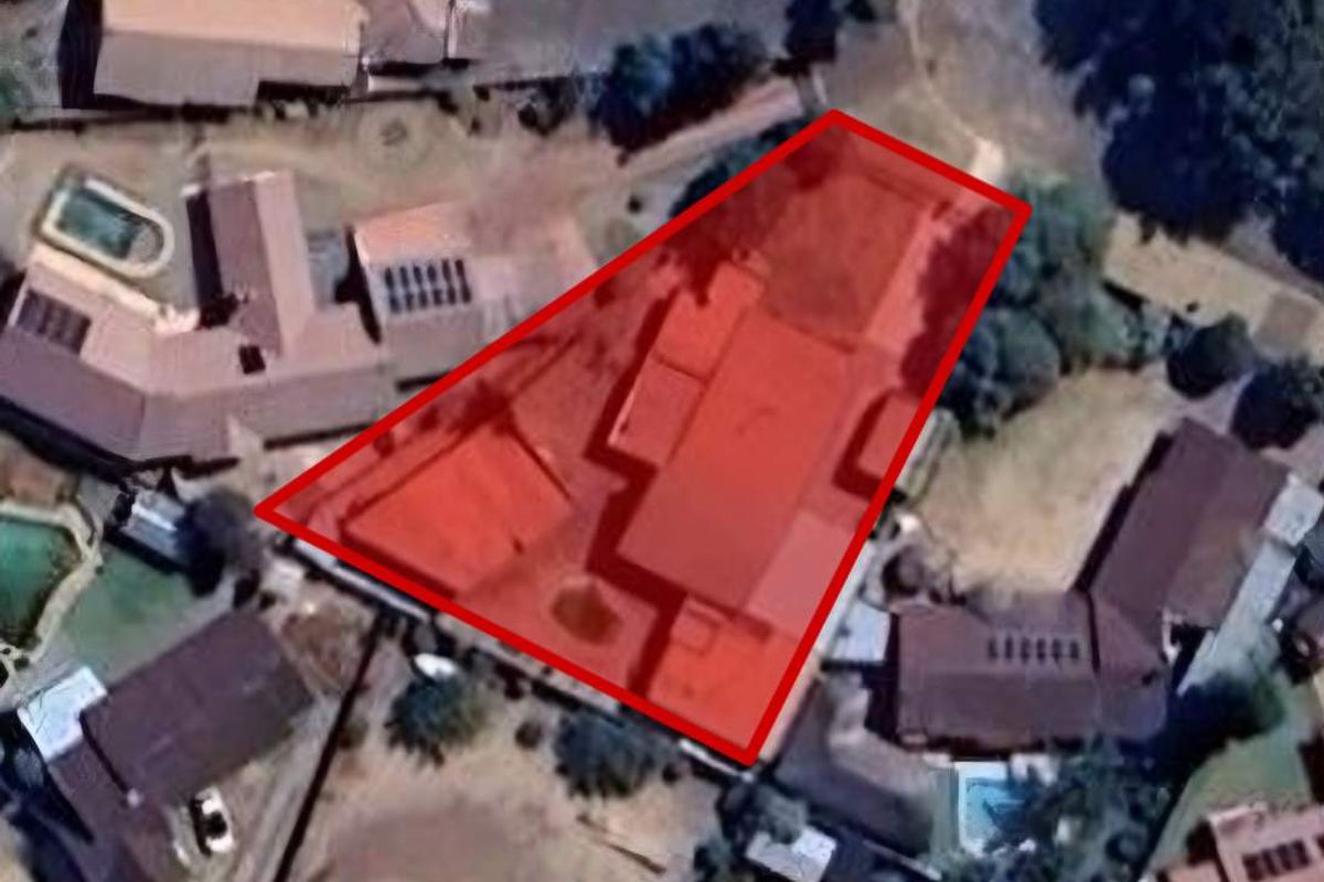 Aerial view of the property showing the building footprint and surrounding residential plot layout.