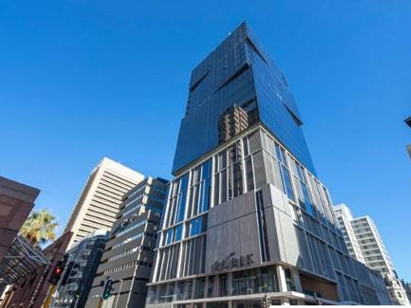 A modern high-rise mixed-use building featuring a contemporary glass and steel facade in an urban setting.