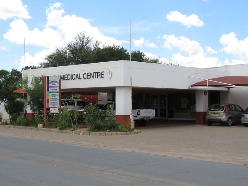 Front elevation of the Rehoboth Medical Centre featuring a covered entrance, paved parking area, and prominent business signage.