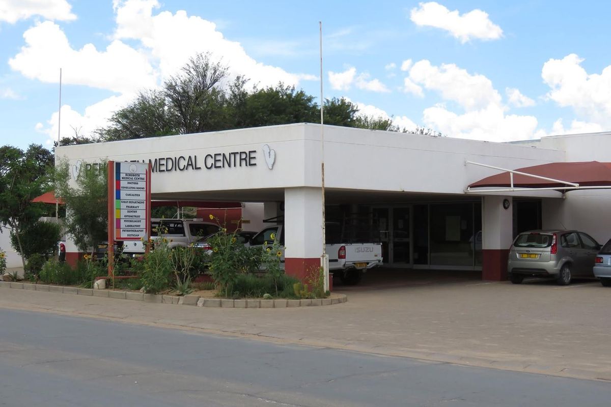 Front elevation of the Rehoboth Medical Centre featuring a covered entrance, paved parking area, and prominent business signage.