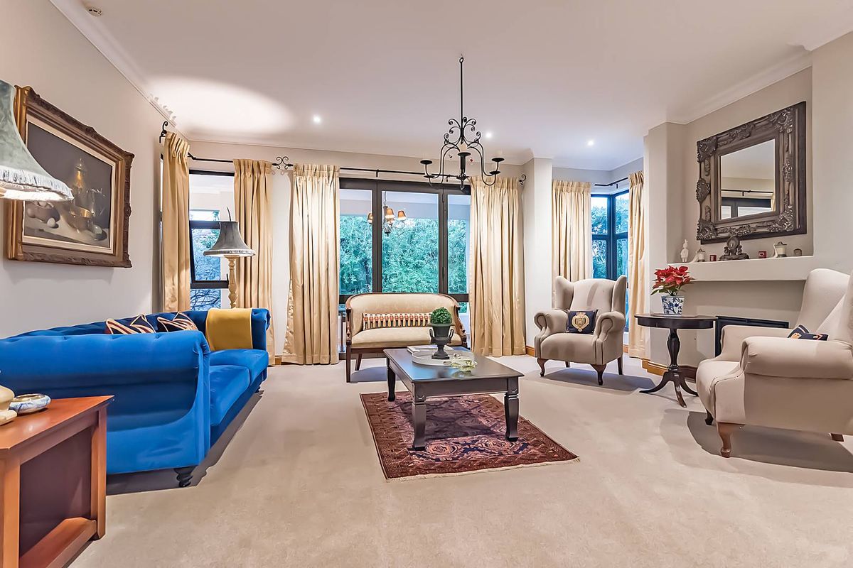 Spacious living room featuring a fireplace, recessed lighting, and large windows with access to the outdoor area.