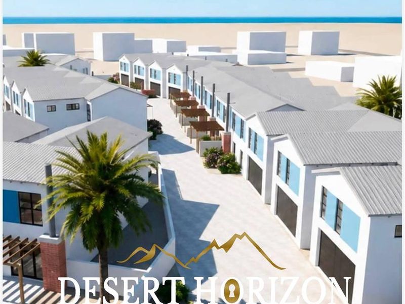 An aerial perspective of a townhouse development featuring uniform pitched roofs, paved driveways, and integrated garage access.