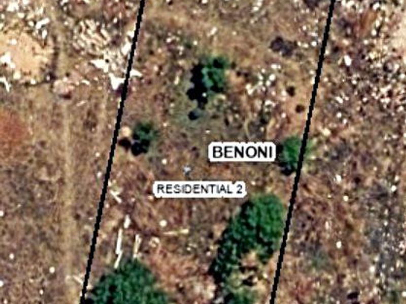 An aerial view of a vacant residential plot in Benoni, showing the property boundaries and existing vegetation.