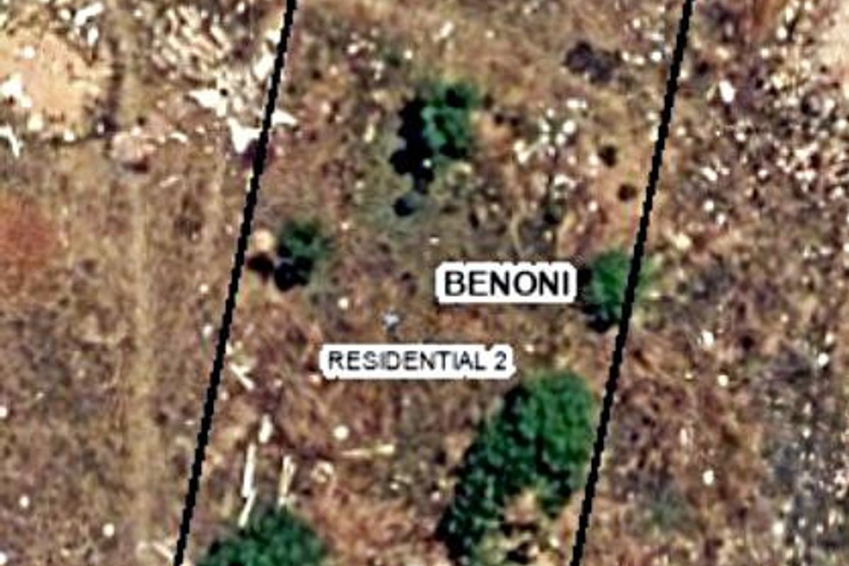 An aerial view of a vacant residential plot in Benoni, showing the property boundaries and existing vegetation.