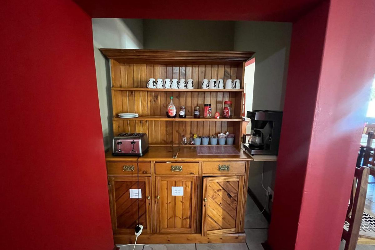 A dedicated breakfast or refreshment station featuring a built-in wooden dresser unit set within a recessed alcove.