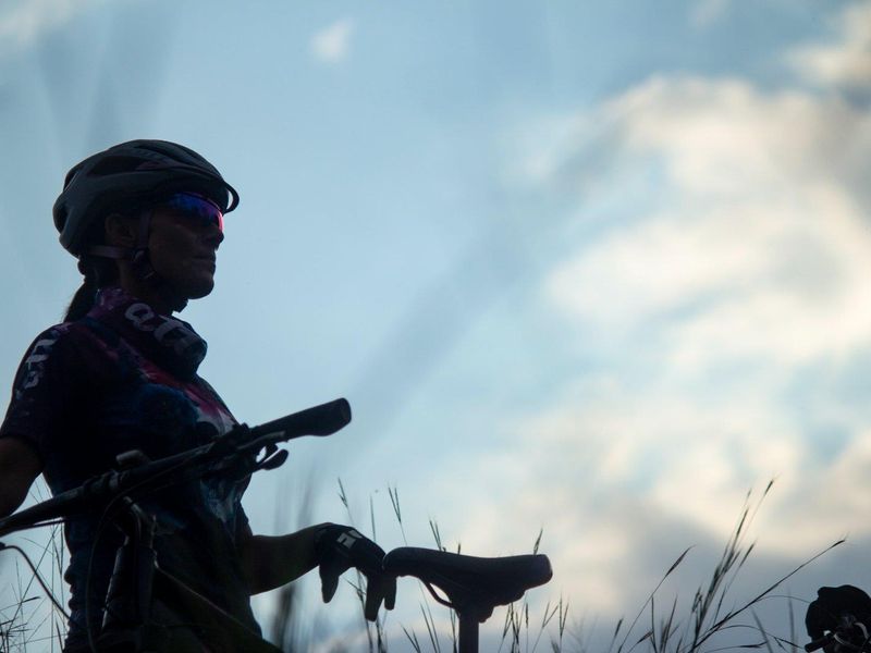 A silhouette of a cyclist against a cloudy sky, providing no information regarding the residential property or land.