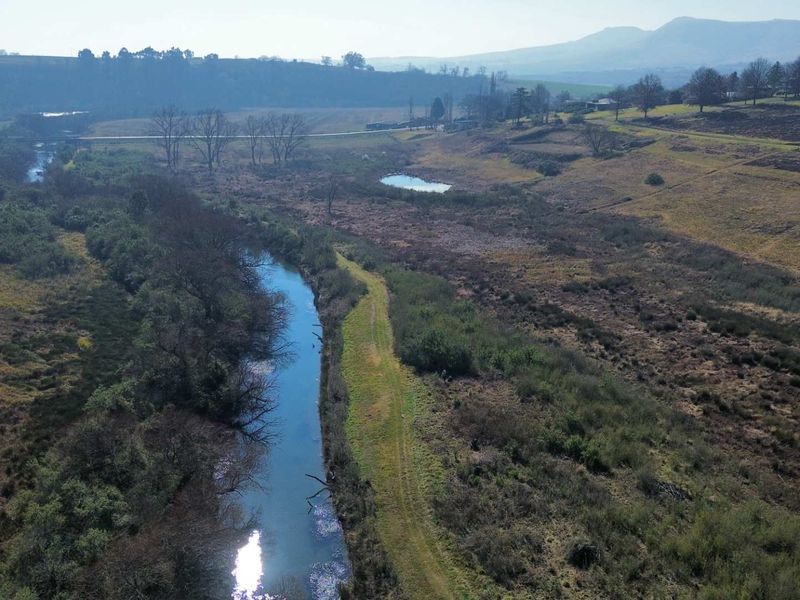 An aerial view of the vacant residential land featuring a natural river and expansive rural landscape.