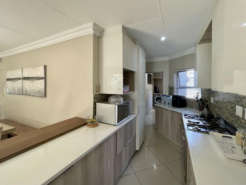 Spacious 4-Bedroom Family Home with Pool, Entertainment Areas & Solar Backup in Highveld - Photo 7