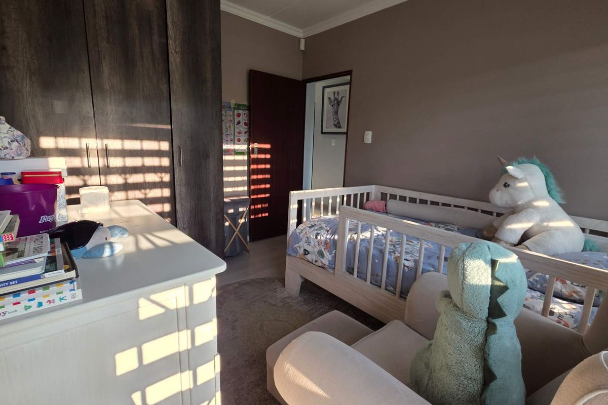 A bedroom featuring built-in dark wood cabinetry and neutral wall tones, providing functional storage space.