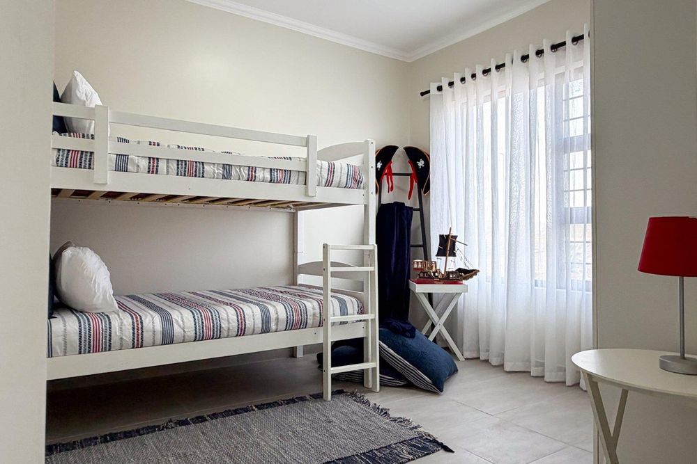 Second bedroom with built-in cupboards.