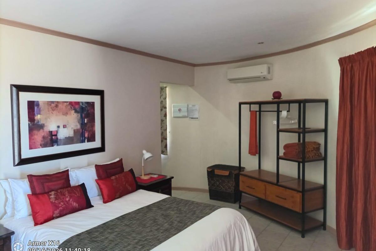 A bedroom featuring tiled flooring, an air conditioning unit, and recessed ceiling lighting.