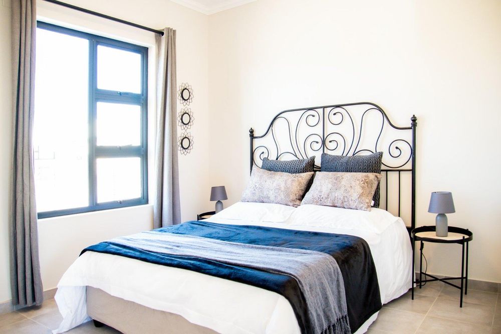 Main bedroom with built-in cupboards and ensuite bathroom.