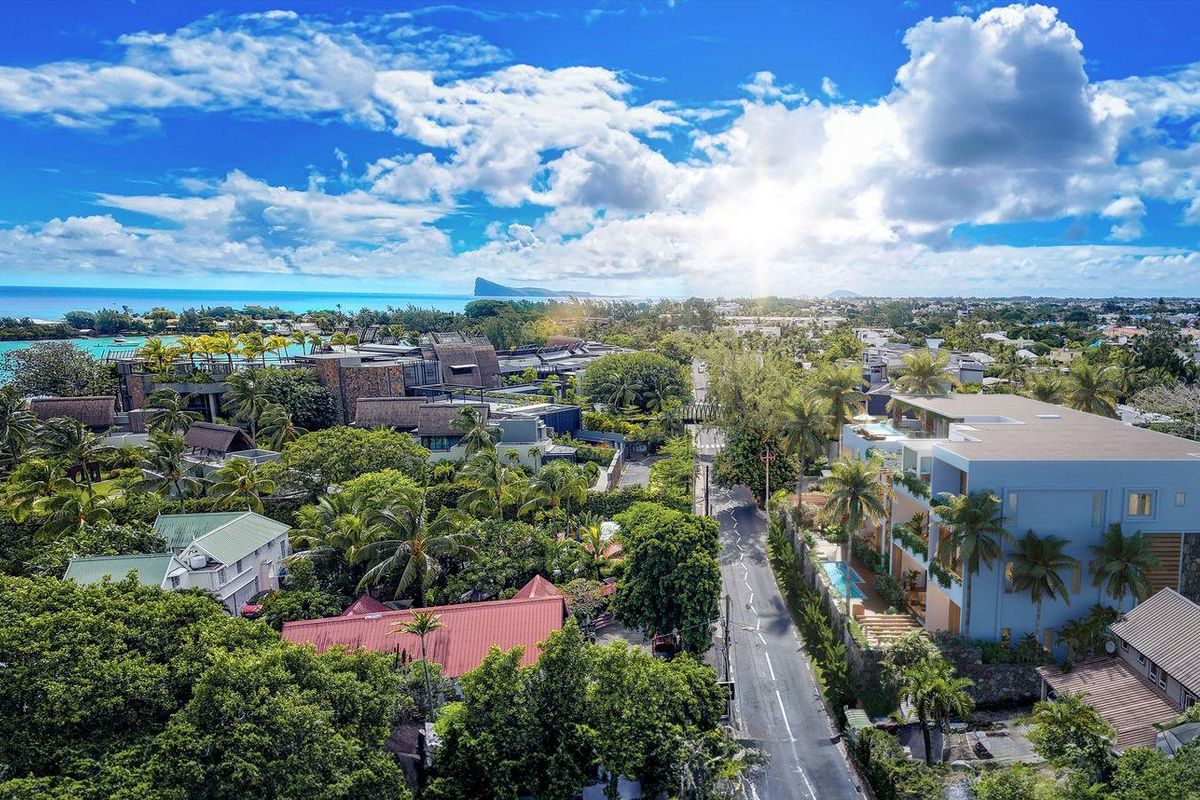 Aerial view of the coastal neighborhood, showcasing the surrounding landscape, proximity to the ocean, and local residential architecture.
