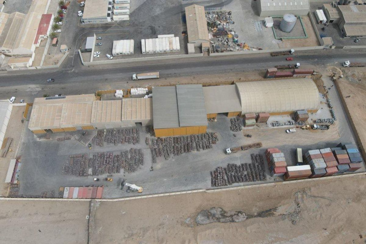 Aerial view of an industrial property featuring multiple warehouse structures, expansive yard space, and perimeter fencing, suitable for logistics or manufacturing operations.