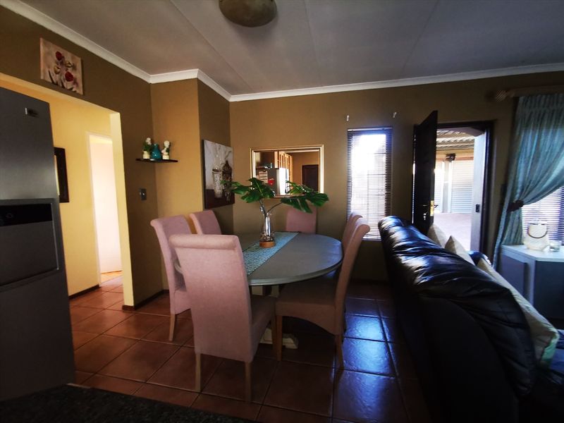 Open plan living and dining area featuring tiled flooring and direct access to an outdoor patio space.