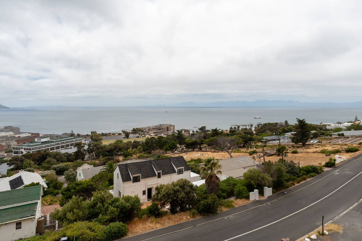 Elevated aerial view overlooking the surrounding coastal landscape, neighborhood, and distant ocean horizon.