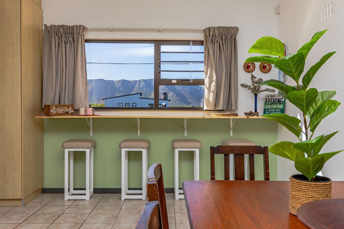Kitchen area featuring a built-in breakfast bar, tiled flooring, and a window with mountain views.