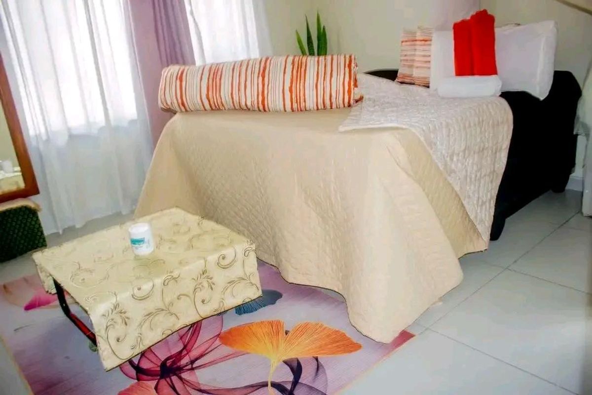 A bedroom featuring tiled flooring and large windows that allow for natural light.