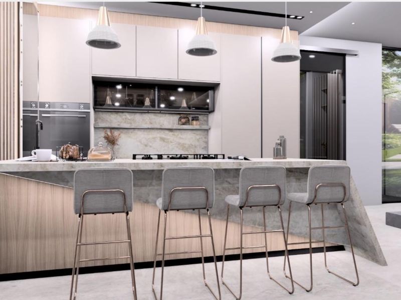 Modern kitchen featuring a stone waterfall island, integrated appliances, custom cabinetry, and elegant pendant lighting in a contemporary open-plan layout.