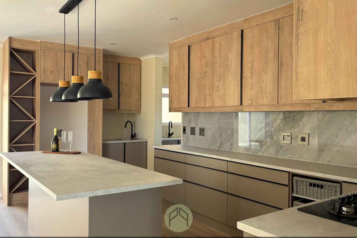 Modern kitchen featuring wood-grain cabinetry, stone-look countertops, a central island, and a sleek marble-effect backsplash.