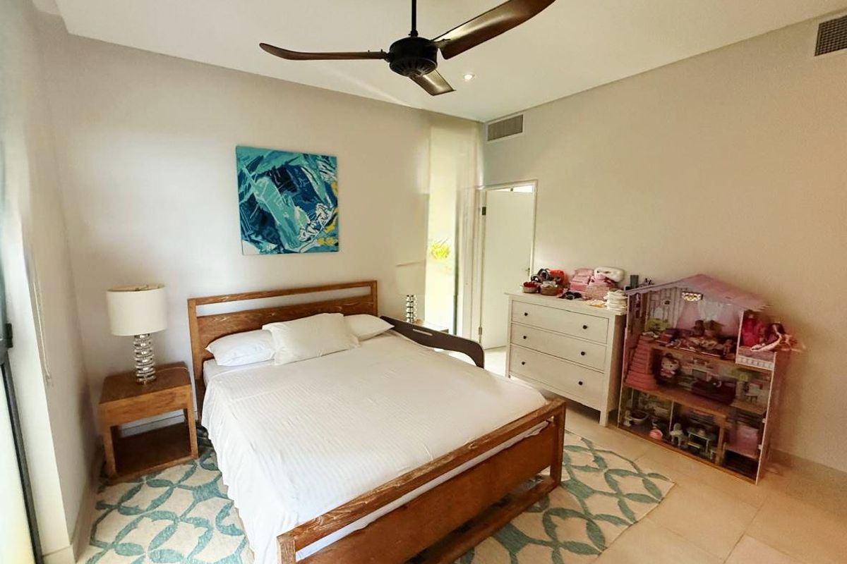 A well-maintained bedroom featuring tiled flooring, a ceiling fan, and recessed lighting, offering a comfortable and functional living space.