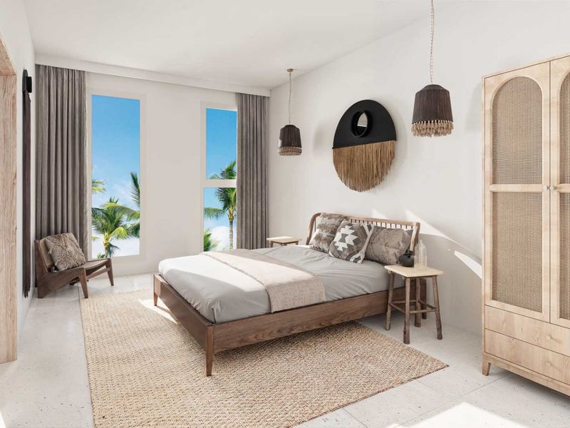 A bright and modern bedroom featuring large windows with tropical views, neutral tiled flooring, and clean architectural lines.