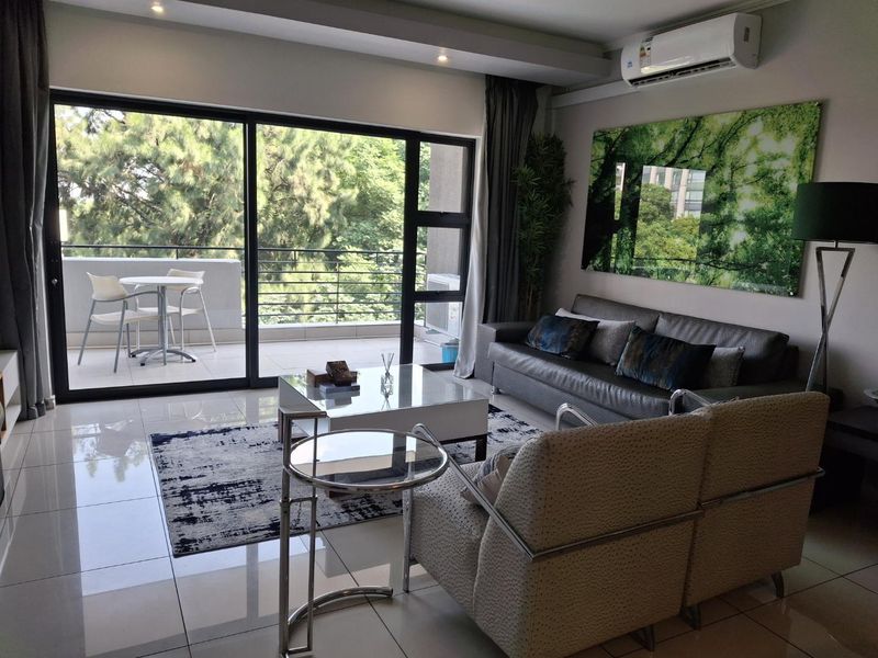 Modern living room featuring large sliding glass doors leading to a private balcony, tiled flooring, and a wall-mounted air conditioning unit.