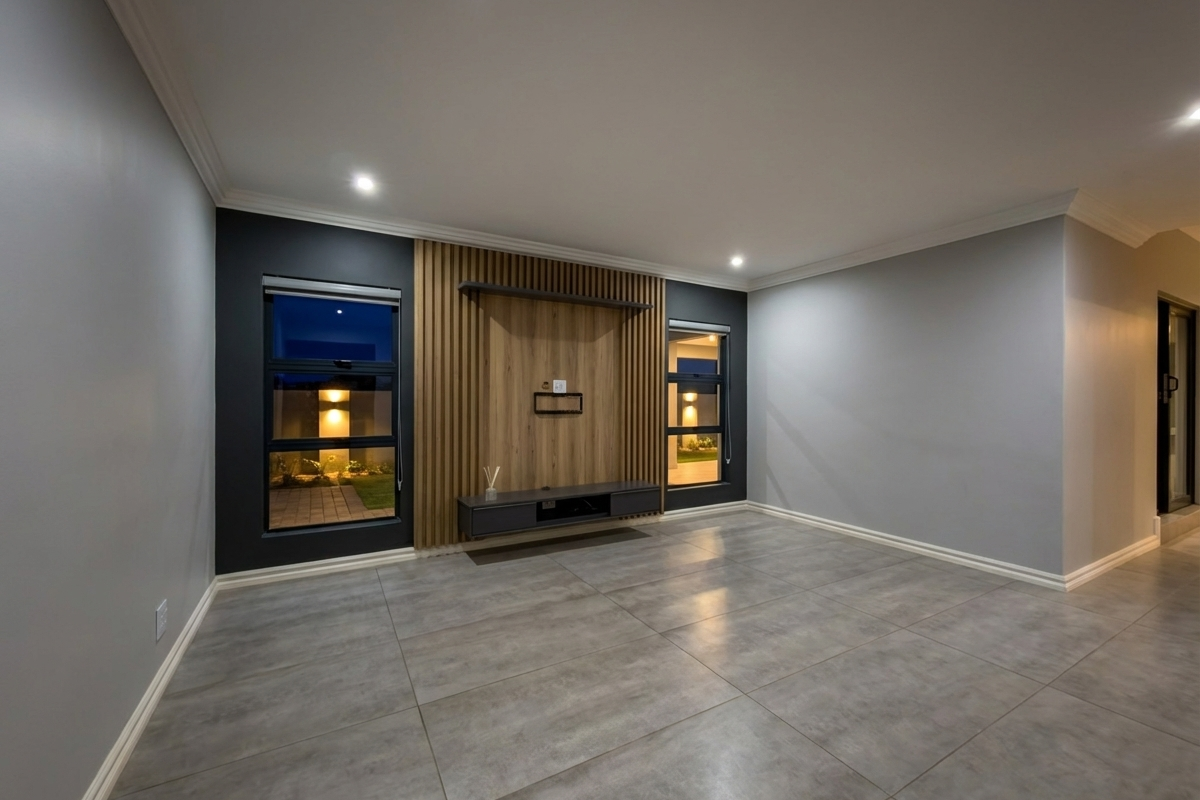 Modern living room featuring large format floor tiles, recessed downlighting, and a contemporary timber-slat feature wall with a built-in floating media console.