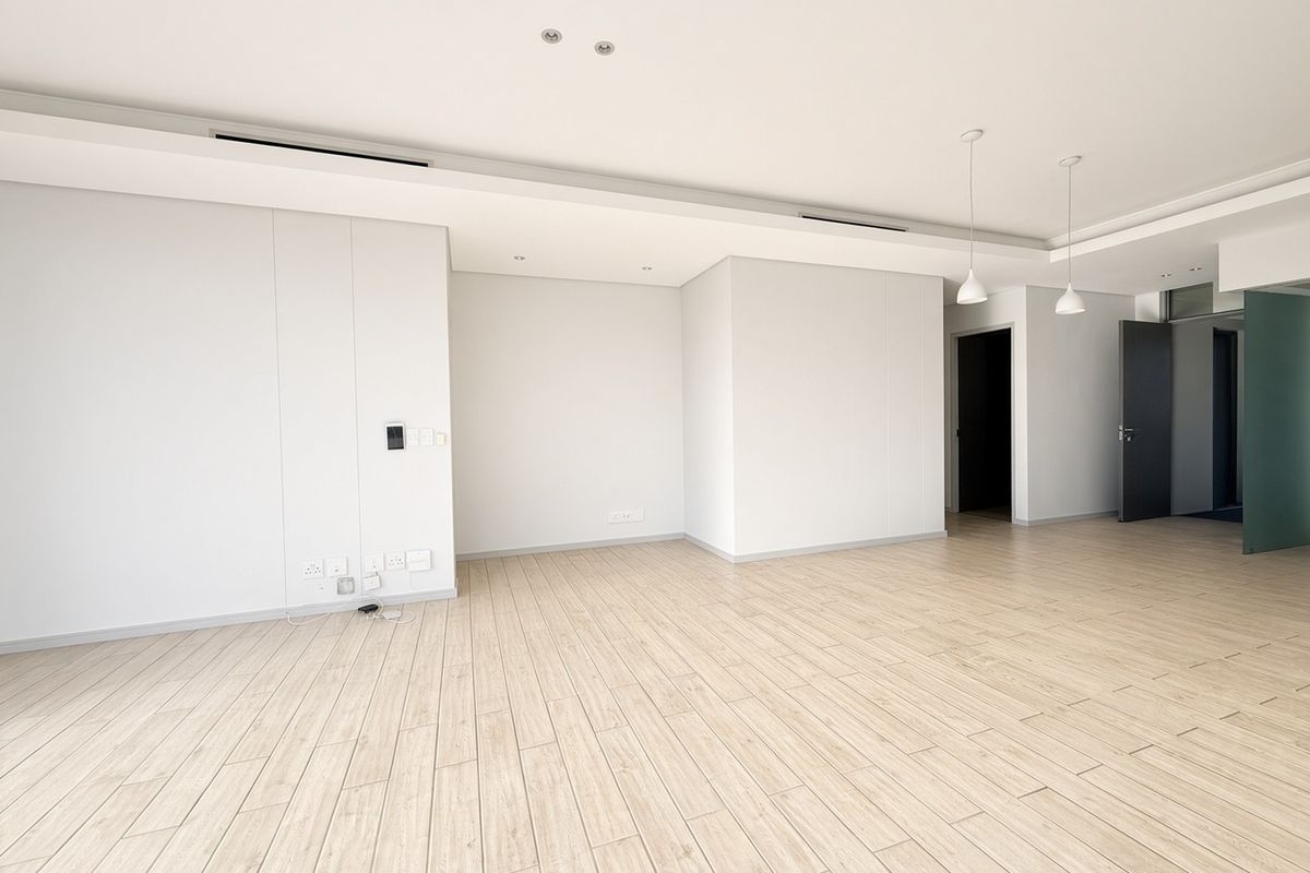 A bright, modern, and spacious open-plan living area featuring neutral wood-look tile flooring, recessed ceiling lighting, and integrated ducted air conditioning.