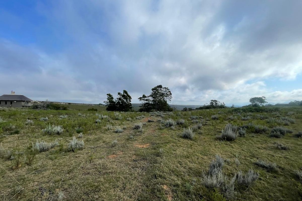 A wide-angle view of the vacant residential land, showcasing the natural landscape and surrounding terrain.