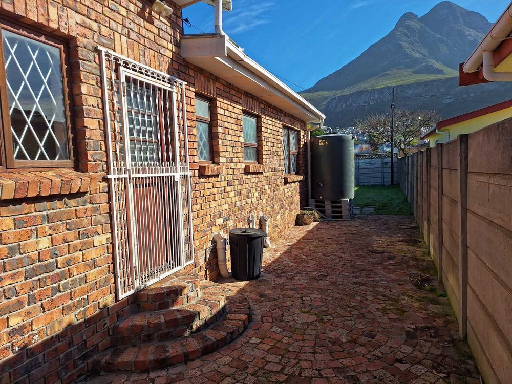 Paved outside kitchen door with water tank