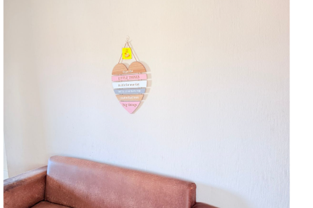 A simple living room area featuring plain walls and ceiling coving.